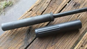 The AMTAC CQB-762 is shown here next to a SilencerCo Specwar 762 for comparison. The CQB is placed in the approximate position where it would be installed so you can see the dramatic overall length impact of the over-barrel design.